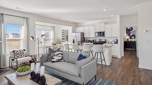 Open concept living space and kitchen with island and countertop seating