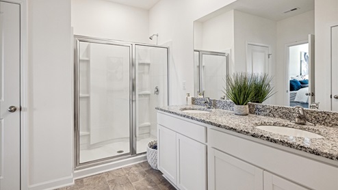 Primary suite bathroom with glass shower