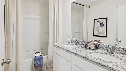 Secondary full bathroom with double vanity