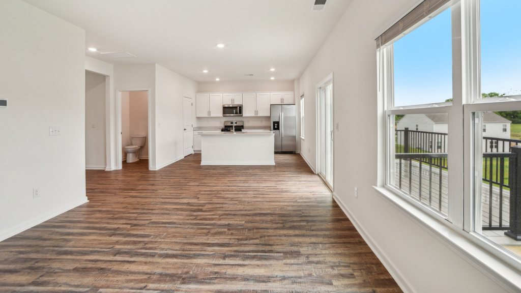 Open living room with several windows for natural lighting.