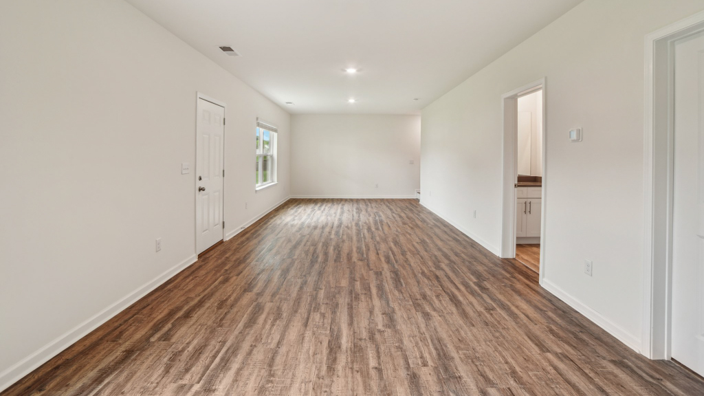 Bottom floor space with large window for natural lighting.