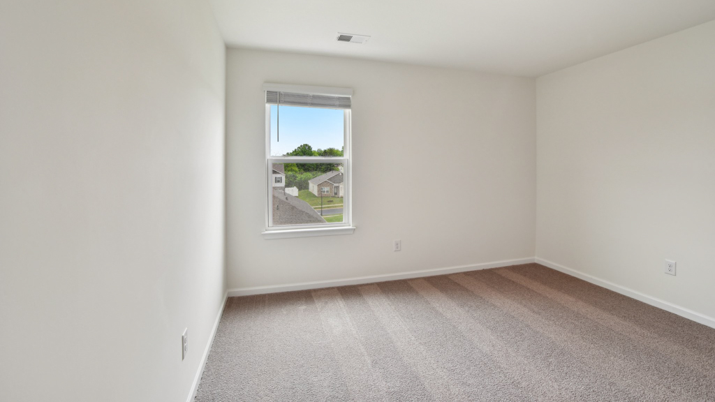 Bedroom with carpeted floors.