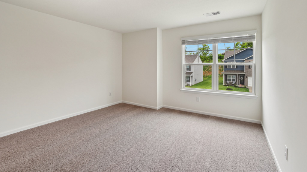 Bedroom with large window for natural lighting.