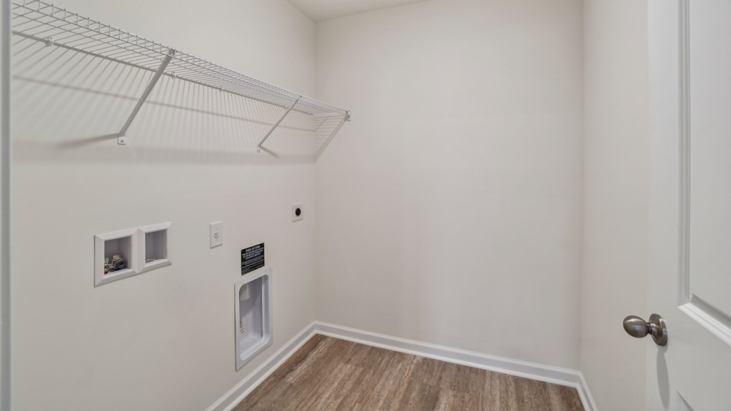 Laundry room with hanging storage racks.