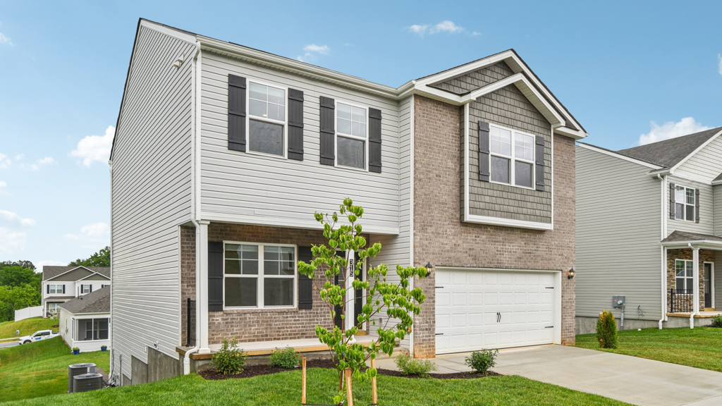 Front exterior of home with landscaped yard.