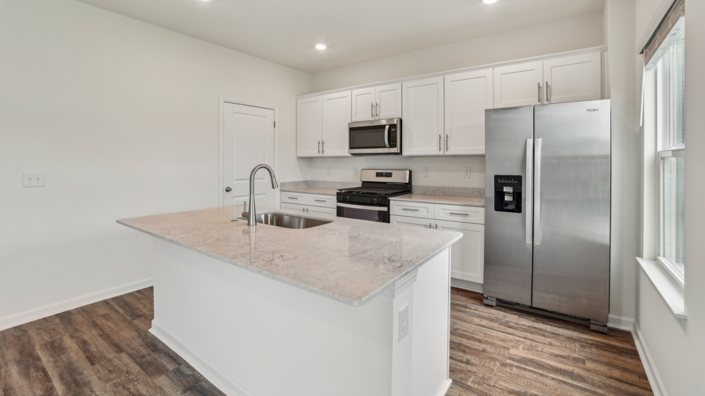 Open kitchen with stainless steel appliances.