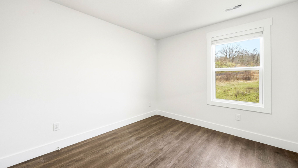 primary bedroom with vinyl flooring and wind