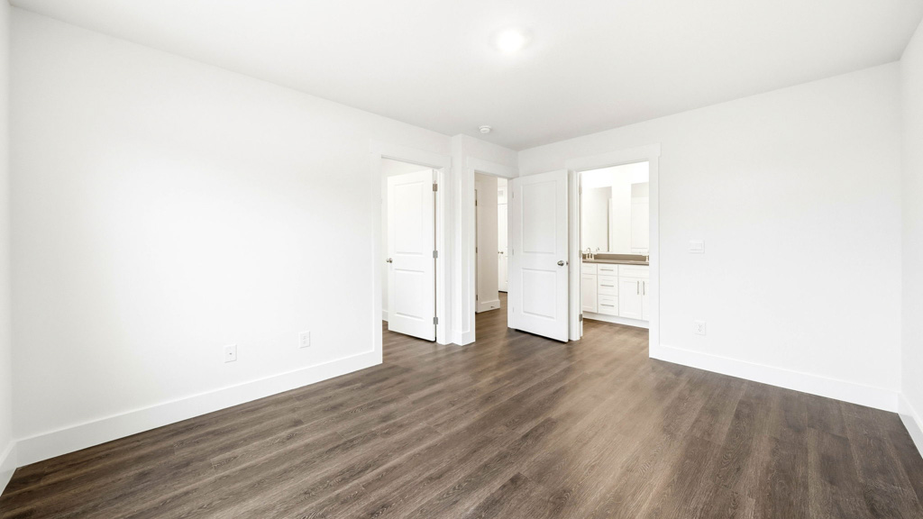 primary bedroom with attached private bathroom