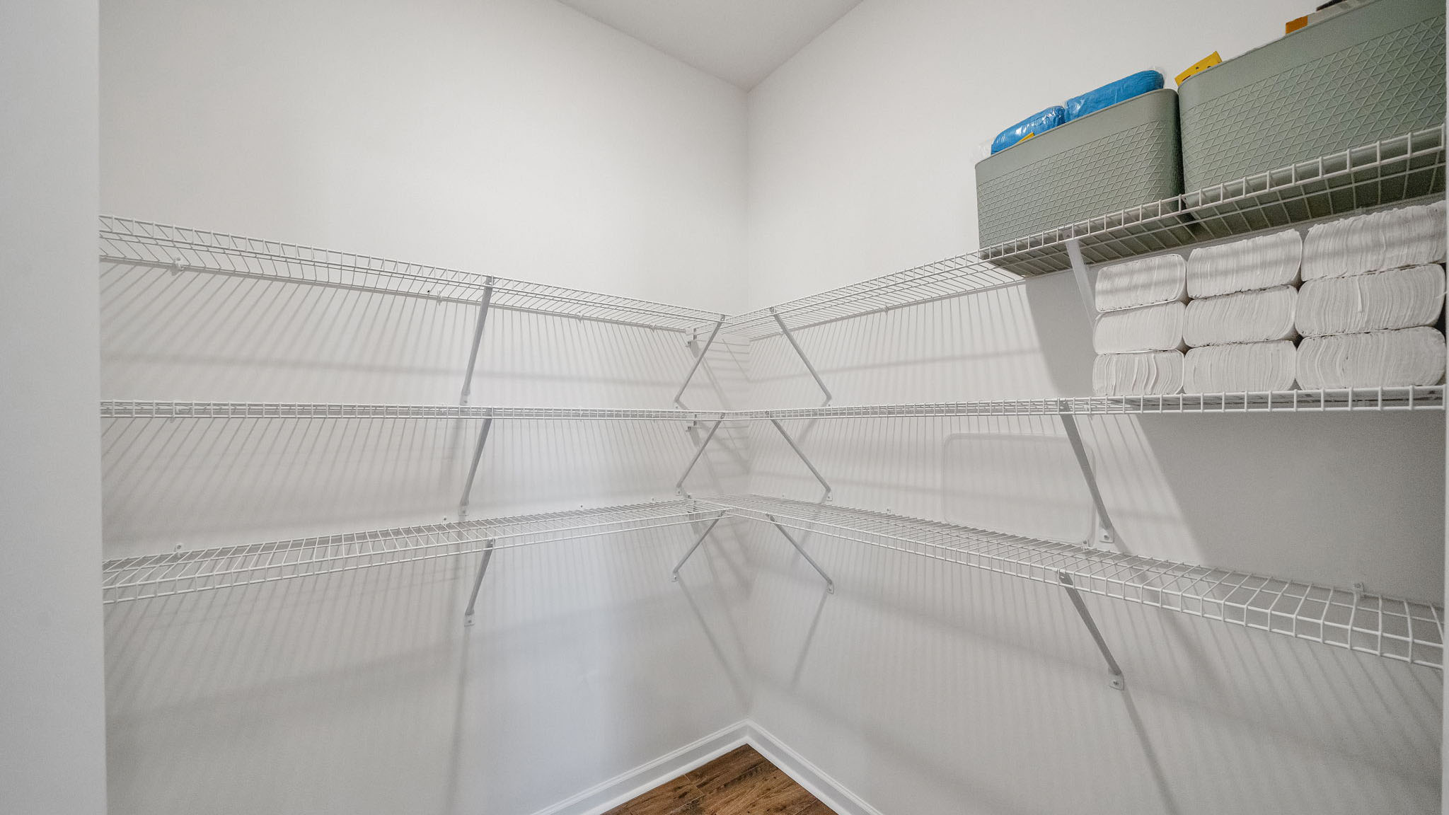 The pantry has shelving and lots of storage space