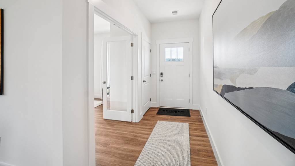 A foyer, entry hall inside front door, next to office, or sitting room adding a welcoming front, direct line of sight to home
