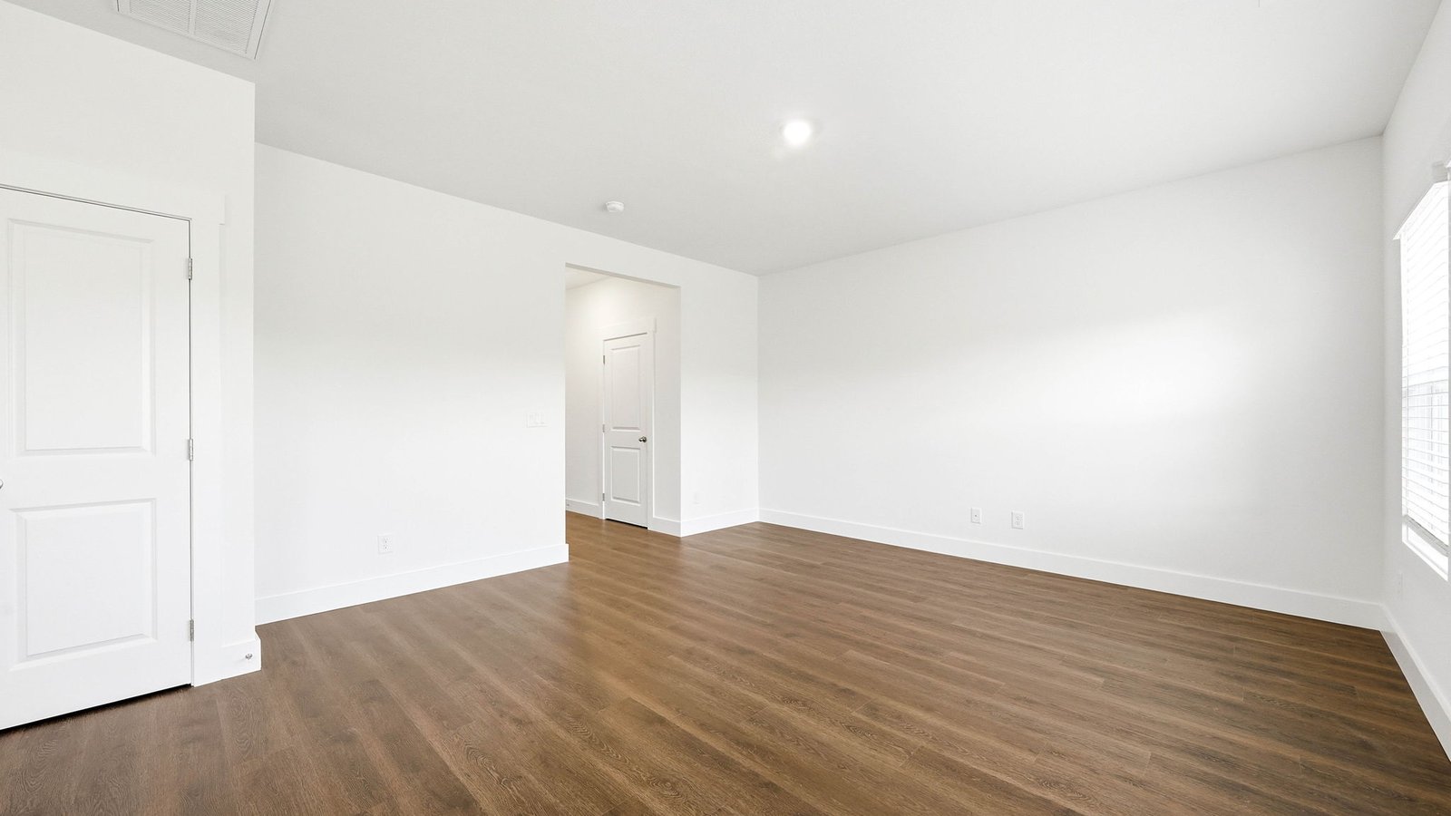 Room with solid flooring and window