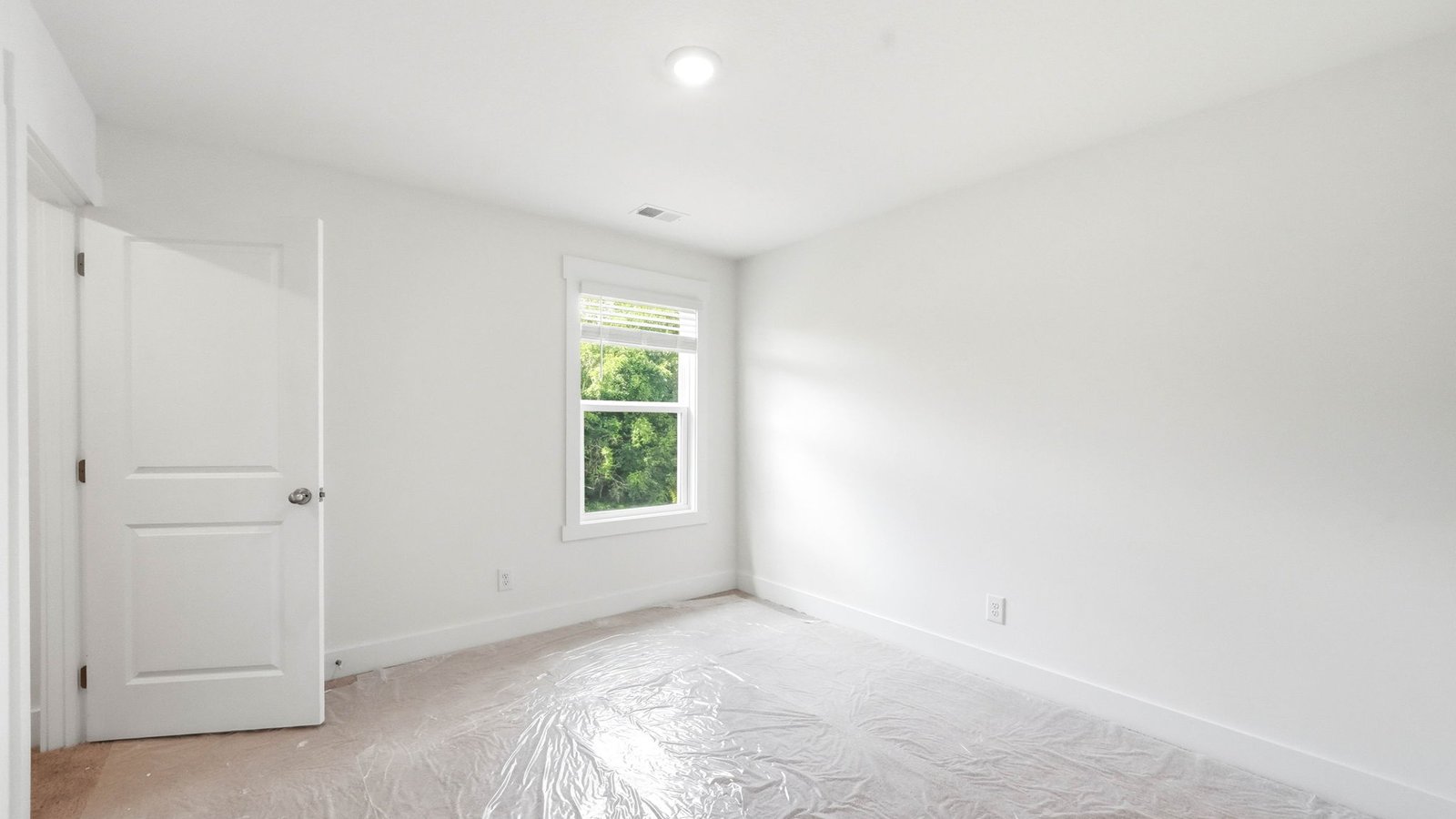 Upstairs bedroom with carpet and window