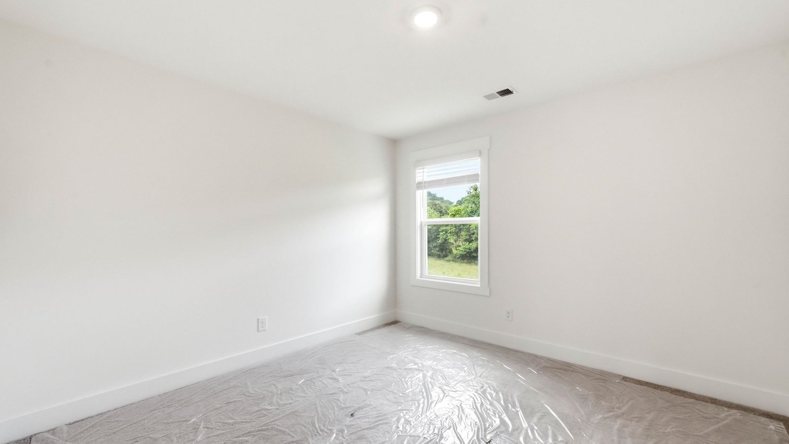 Upstairs bedroom with carpet and window