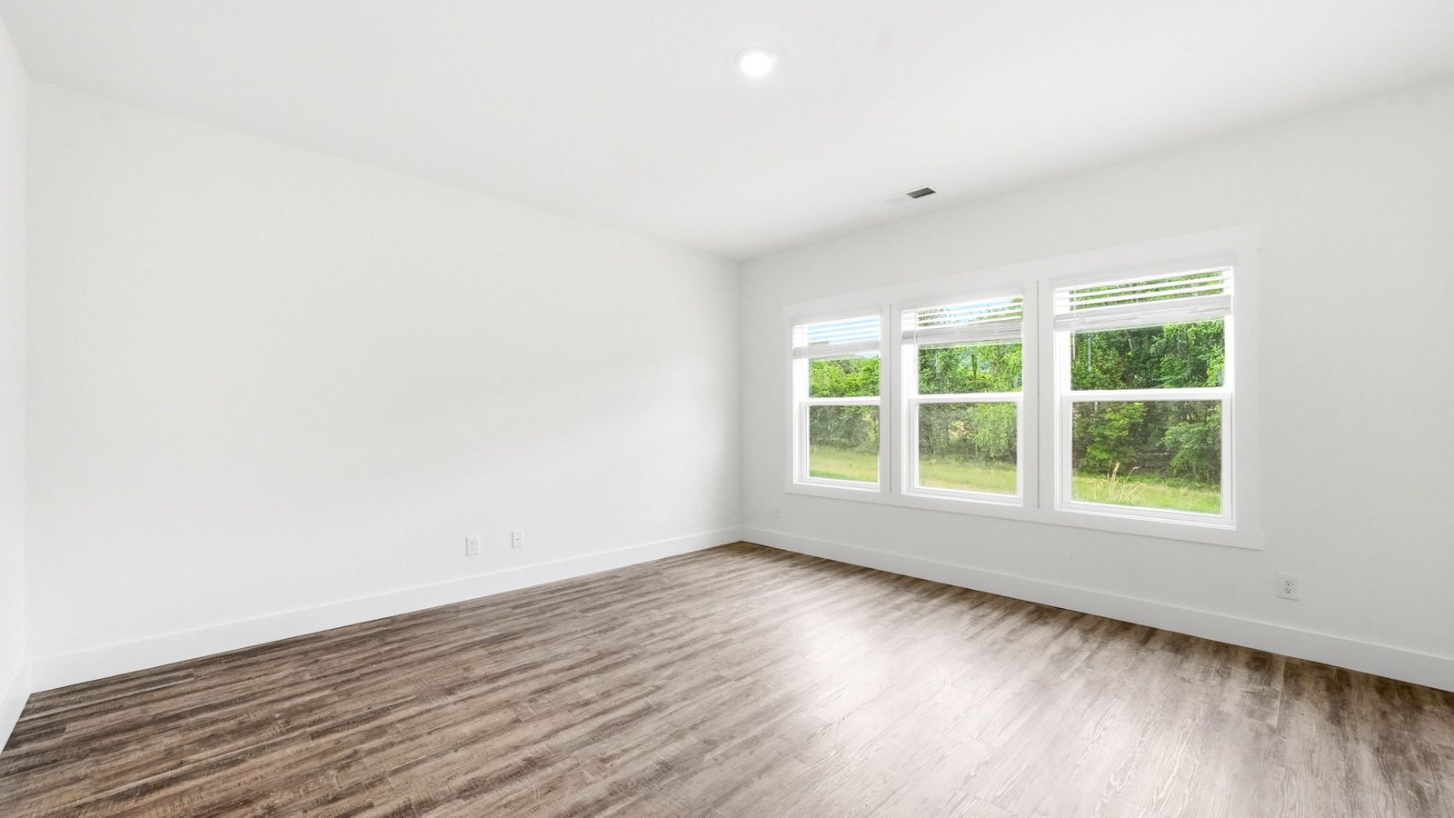 Living room with windows open to kitchen