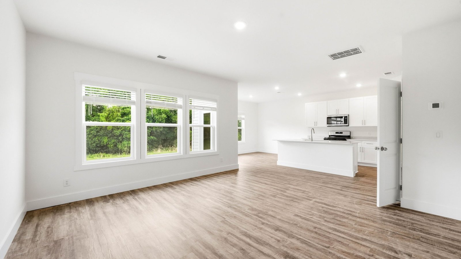 Living room with windows open to kitchen