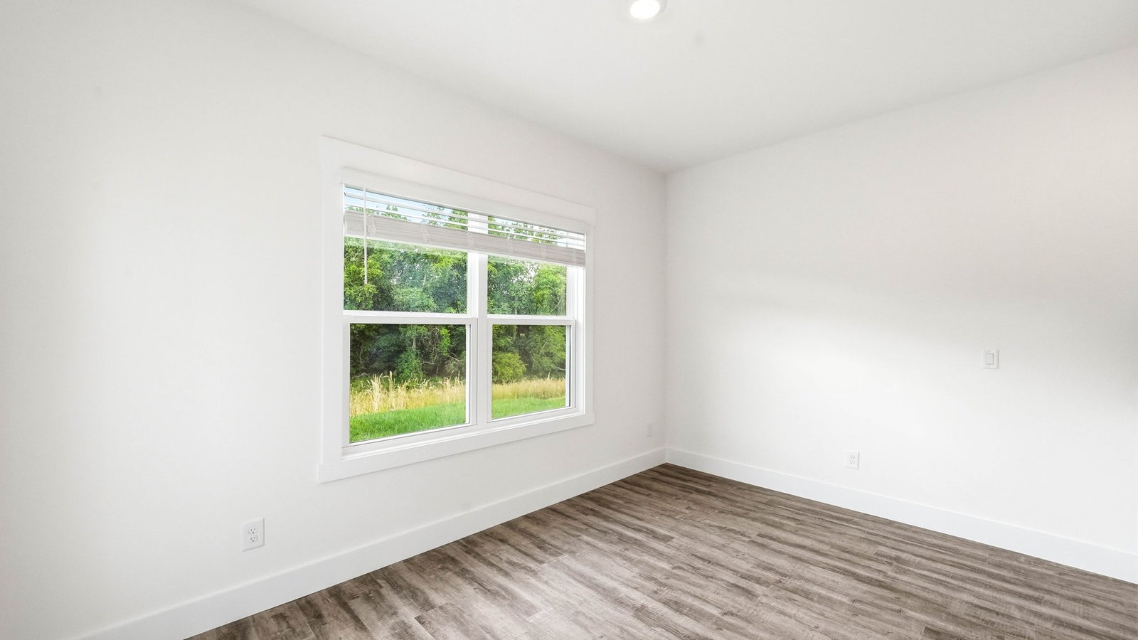 Bedroom with hard flooring and window