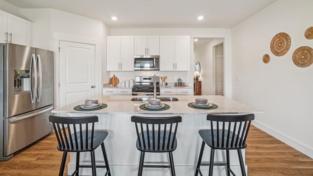 Central kitchen island adds a sink, seating, designed to anchor the home, pantry, prep zones, perfect for entertaining, everyday life