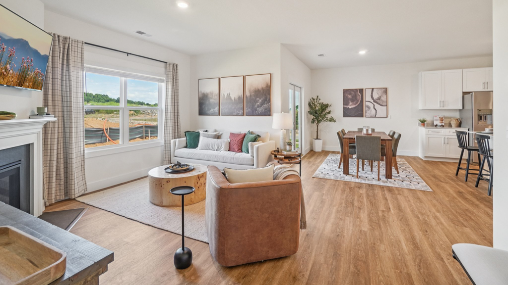 Living room with modern fixtures, electric fireplace, convenient central traffic flow throughout Saint Andrews Garth