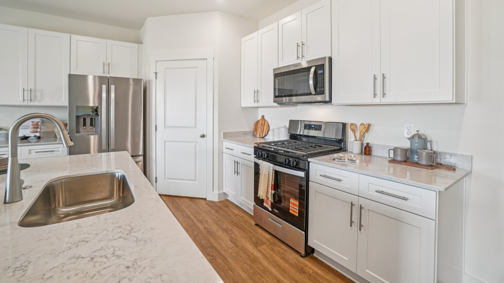 New appliance suite included, our larger kitchen island with seating anchor the kitchen, next to dining, great rooms, pantry