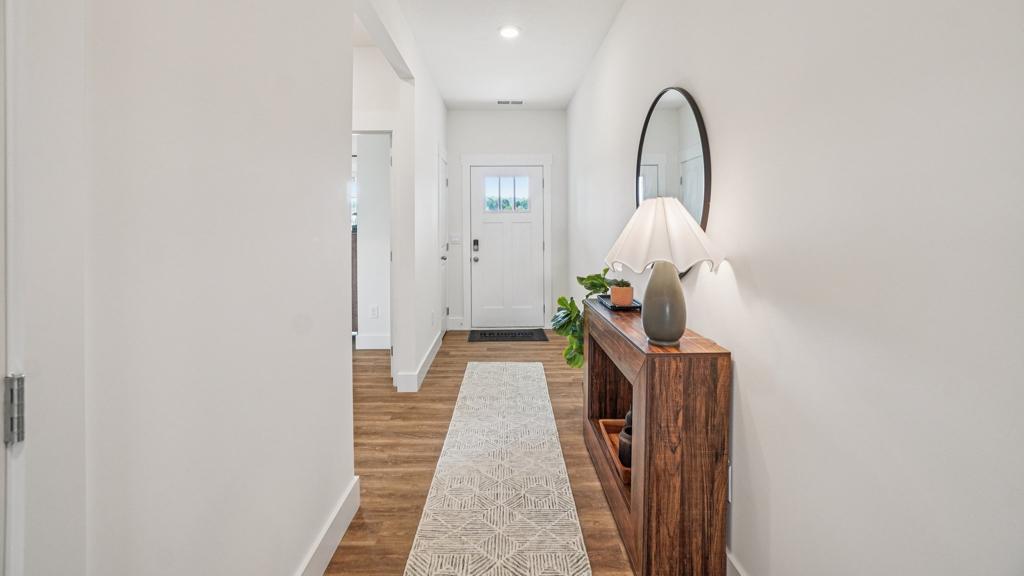 Entry hallway looking from front porch to open designed flex and living spaces, upstairs access Saint Andrews Garth
