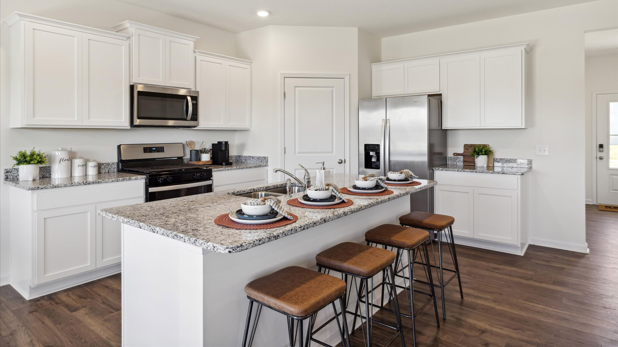 Spacious Kitchen island in this new home with sink, dining areas, daily prep zones, for entertaining and daily life