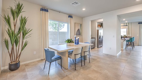 The Spectrum Falls 2988 model Dining Room adjacent to the kitchen with a table and window.