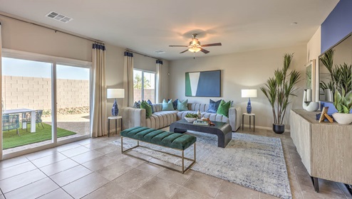 The Spectrum Falls 2988 Plan open concept Great Room with ceramic tile flooring and large windows.