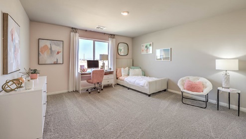 Bedroom Four in our Spectrum Falls 2988 model with carpet flooring and a window.