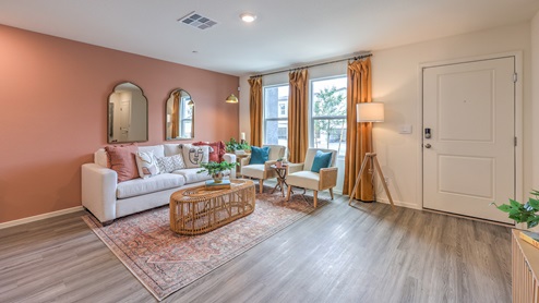 The Spectrum Trails 1309 Plan open concept Great Room with LVP panel flooring and two windows