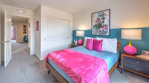 Bedroom Three in our Spectrum Trails 1410 model with carpet flooring, a sliding closet and one window.