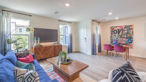 The Spectrum Trails 1410 Plan open concept Great Room with LVP panel flooring and two windows