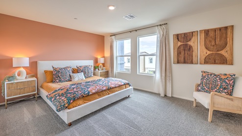 The Bedroom One Suite in our Spectrum Trails 1309 model with carpet flooring, a walk-in closet, windows, and recessed ceiling lights.