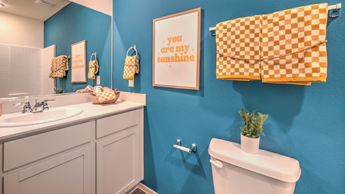 Bathroom Two in our Spectrum Trails 1309 model with quartz/marble fusion countertops at the bath vanity, a walk-in shower, and mirror.