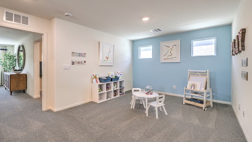 The loft in our Cambria Bay 1865 plan with carpet flooring and two windows
