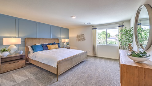 The Bedroom One Suite in our Cambria Bay 1865 model with carpet flooring, recessed ceiling lights, and a walk-in closet.