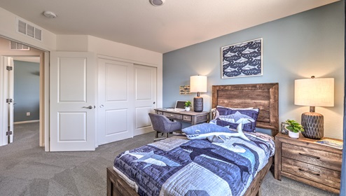 Bedroom Two in our Cambria Bay 1865 model with carpet flooring, a sliding closet, and one window.