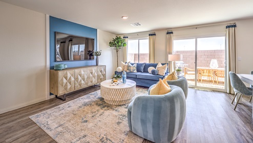 The Cambria Bay 1865 Plan open concept Great Room with LVP panel flooring, large windows, and a sliding door to the backyard.