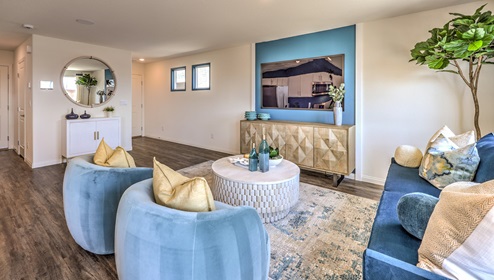 The Cambria Bay 1865 Plan open concept Great Room with LVP panel flooring, large windows, and a sliding door to the backyard.