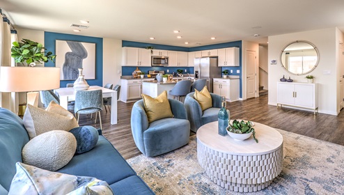 The Cambria Bay 1865 Plan open concept Great Room with LVP panel flooring, large windows, and a sliding door to the backyard.