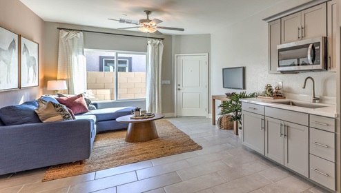 Our Symmetry Manor 2754 Multigen with a Whirlpool stainless steel refrigerator, sink, shaker style cabinets, and granite countertops.
