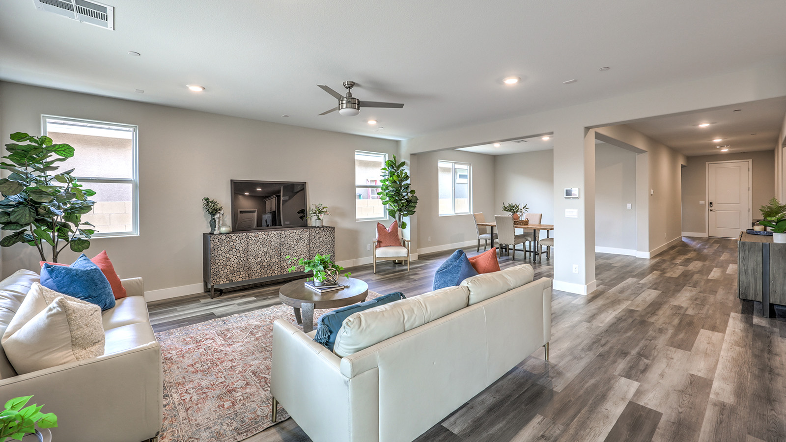 The Symmetry Manor 2754 Plan open concept Great Room with ceramic tile flooring and large windows.