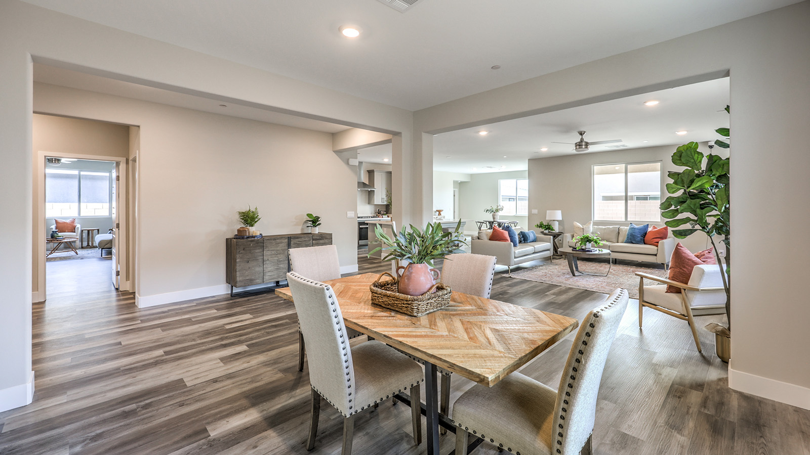 The Symmetry Manor 2754 model Dining Room adjacent to the kitchen and great room with a table and large window.