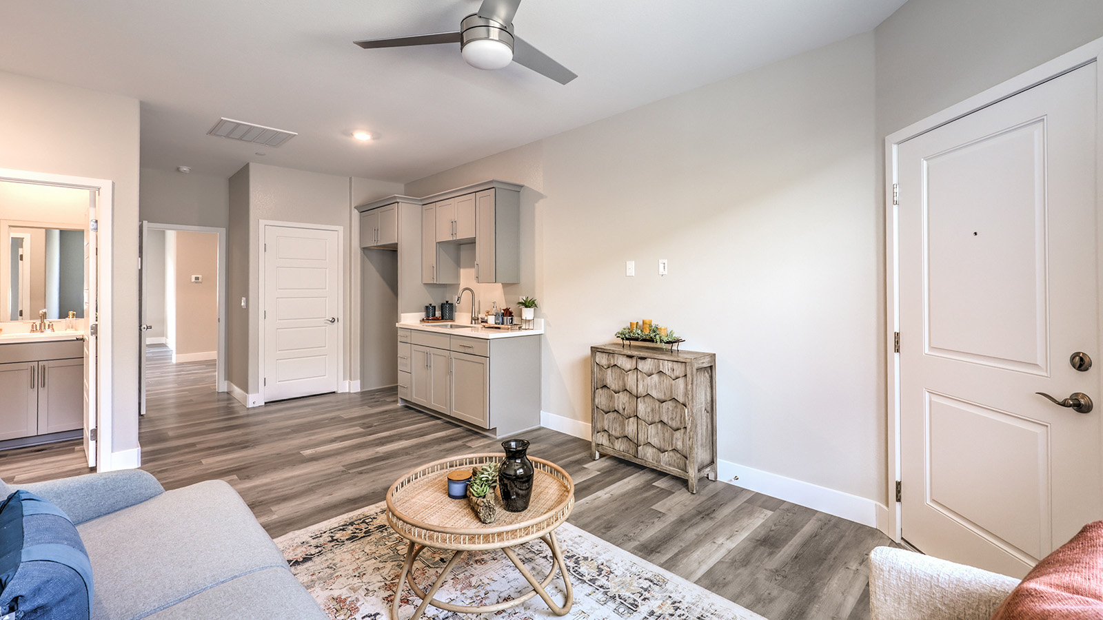 Our Symmetry Manor 2754 Multigen with a Whirlpool stainless steel refrigerator, sink, shaker style cabinets, and granite countertops.