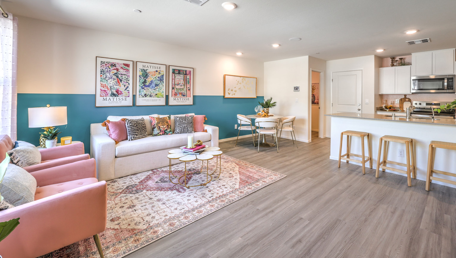 The Tempo Trails 1309 Plan open concept Great Room with LVP panel flooring and a view of the kitchen.