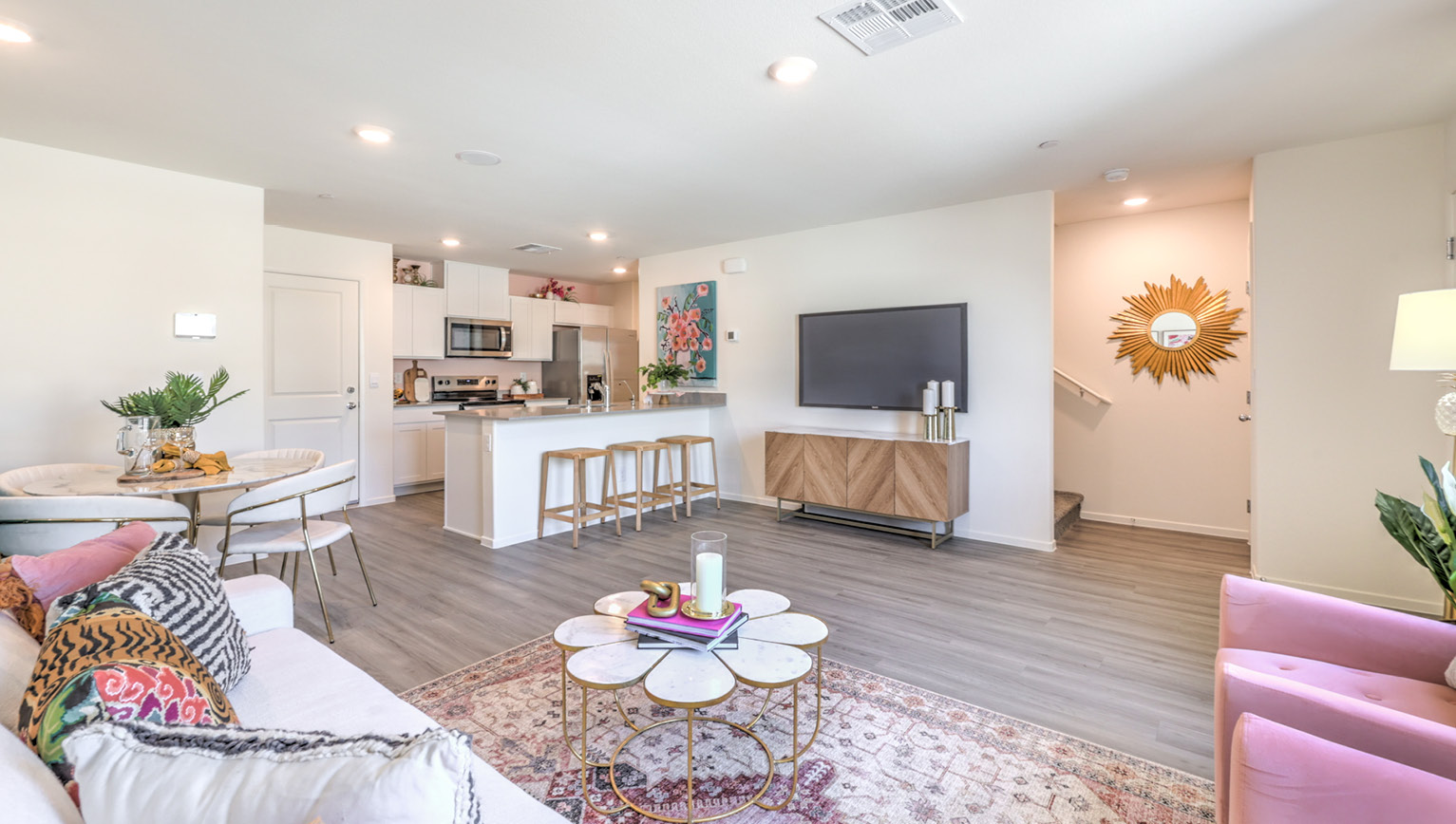 The Tempo Trails 1309 Plan open concept Great Room with LVP panel flooring and a view of the kitchen.