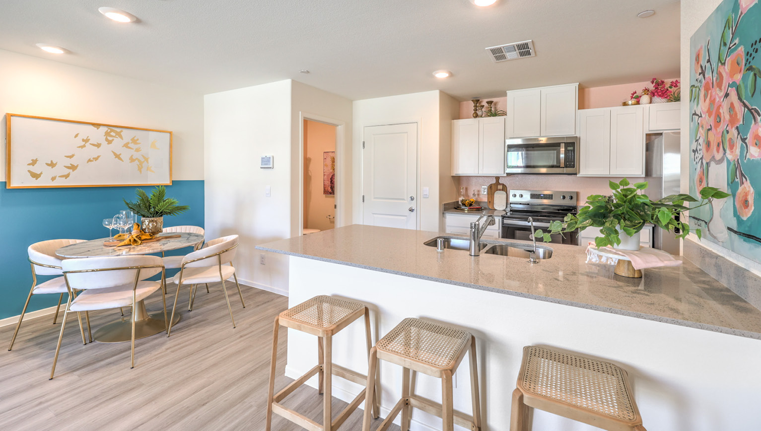 Our 1309 model kitchen in the Tempo Trails Community with white shaker style cabinets, quartz countertops, and Whirlpool Stainless Steel appliances.