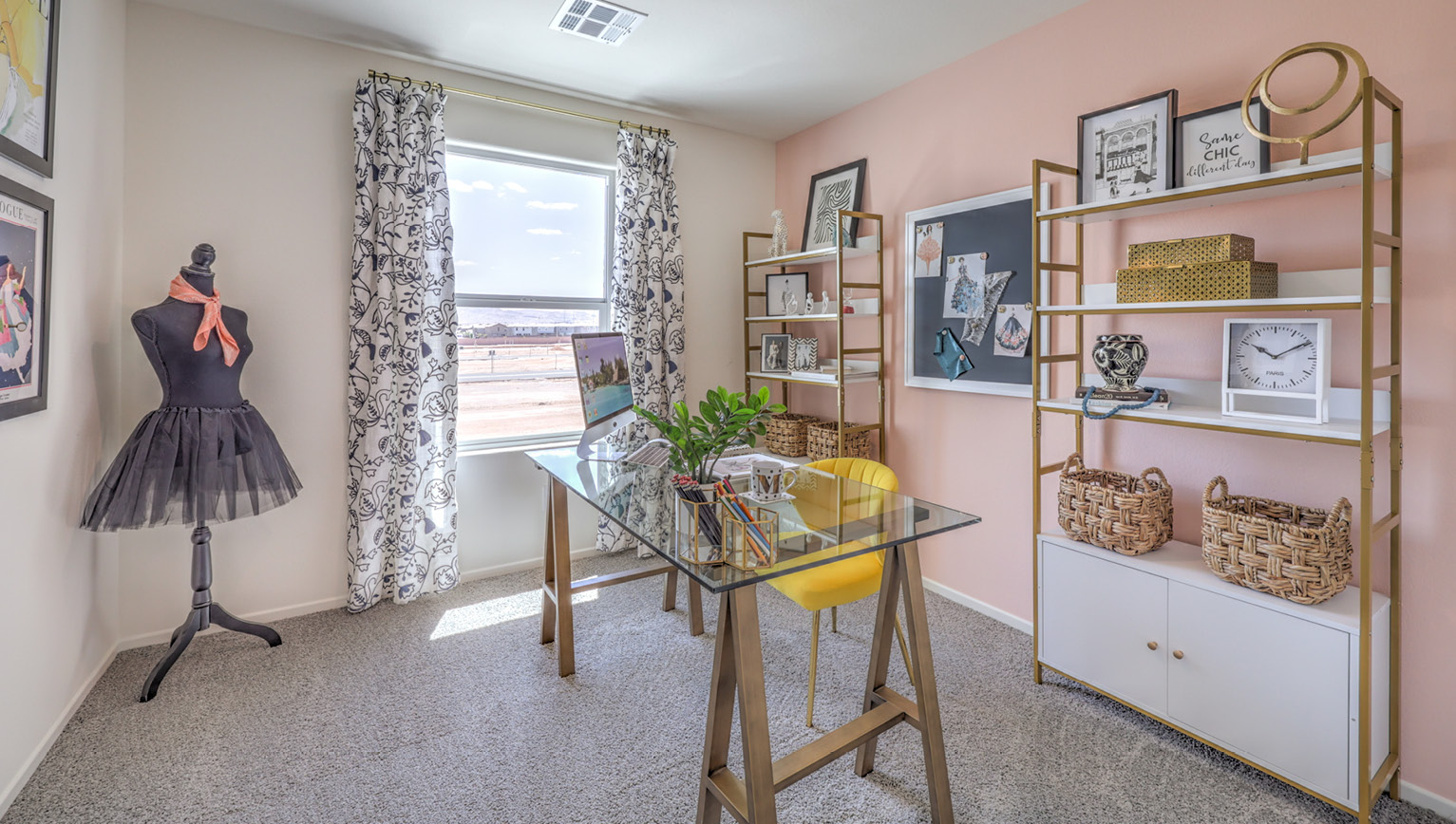 The Office/Bedroom three option in our Tribute Trails 1309 model with carpet flooring and a window, furnished with a desk and chair.