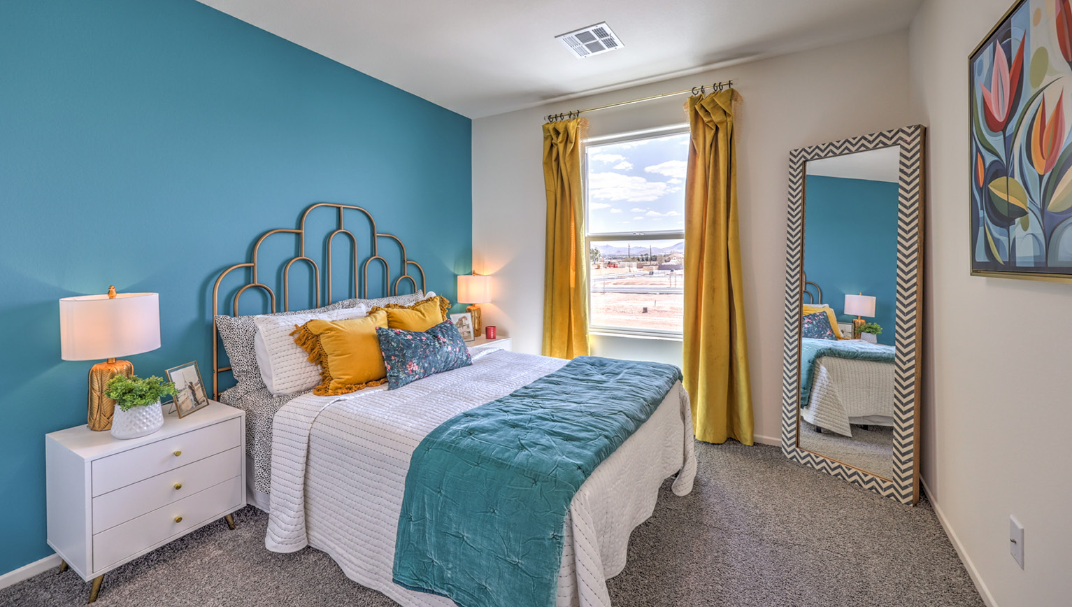 Bedroom Two in our Tribute Trails 1309 model with carpet flooring, an accent wall, and one window.