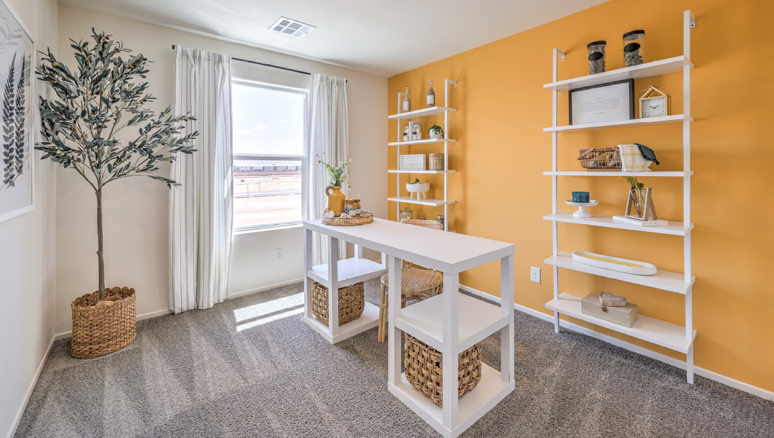 The Office/Bedroom Two option in our Tempo Trails 1410 model with carpet flooring and a window, furnished a desk and chair.