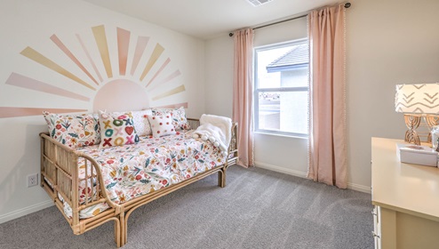 Bedroom Three in our Symmetry Bay 1865 model with carpet flooring, a sliding closet, and one window.